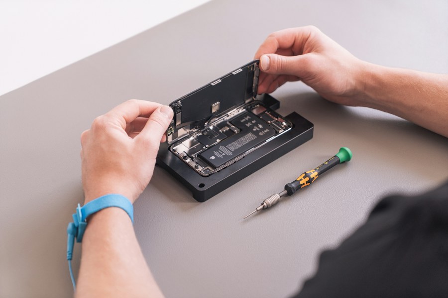 Sample photo of hands working on an opened device; not iSales Dublin staff